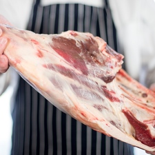 Butcher Holding Leg Of Mutton