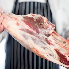 Butcher Holding Leg Of Mutton